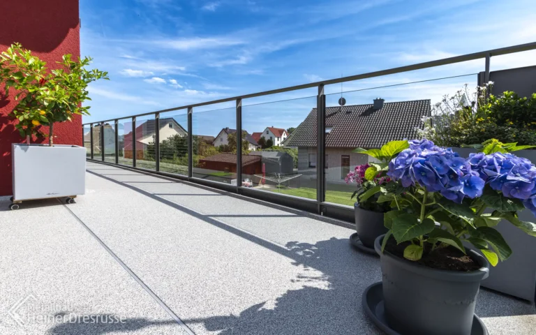 Balkon Innensansicht mit Glasgeländer und Boden aus Faserzementplatten